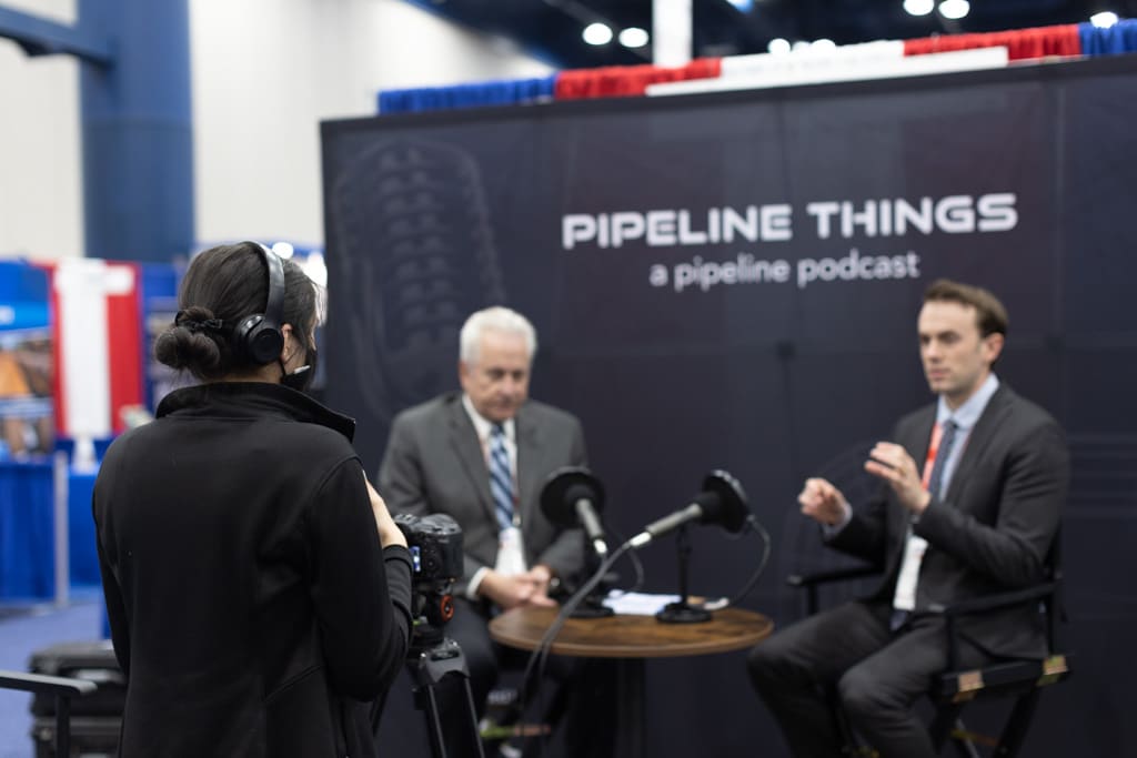 View of ADV Marketing producer filming a live podcast at a conference